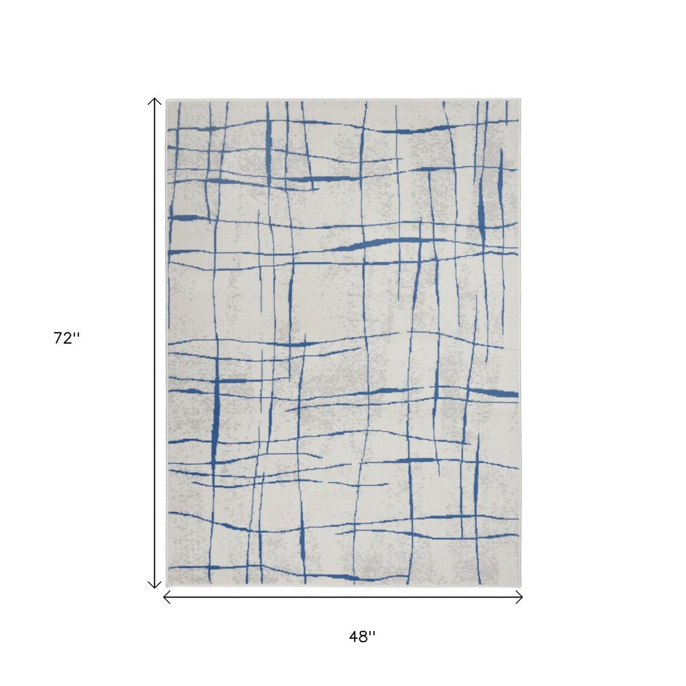 4' X 6' Ivory And Blue Geometric Distressed Area Rug