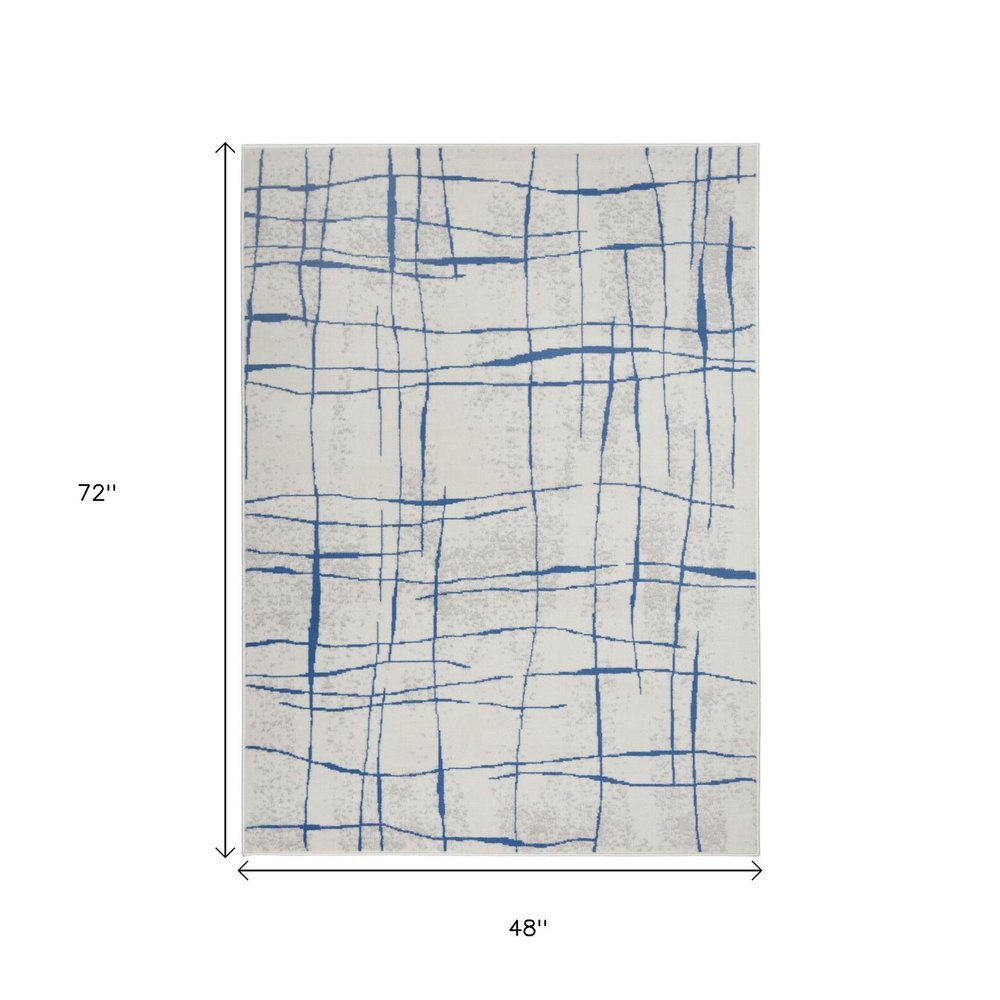 4' X 6' Ivory And Blue Geometric Distressed Area Rug
