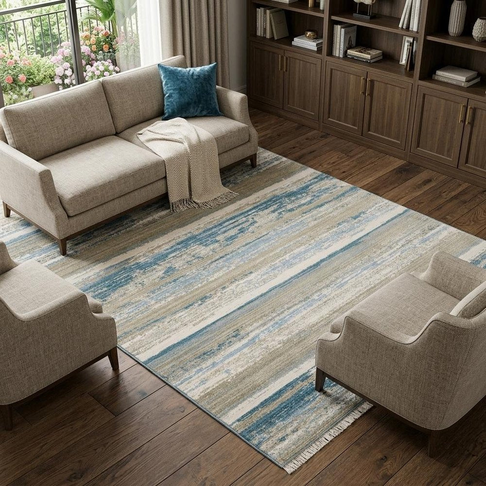 8' X 11' Ivory Beige Grey Blue And Tan Abstract Power Loom Stain Resistant Area Rug With Fringe