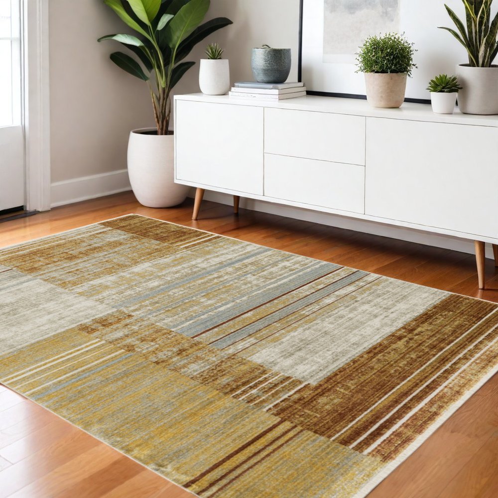 4' X 6' Rust Gold Blue Grey Ivory And Tan Geometric Power Loom Stain Resistant Area Rug With Fringe