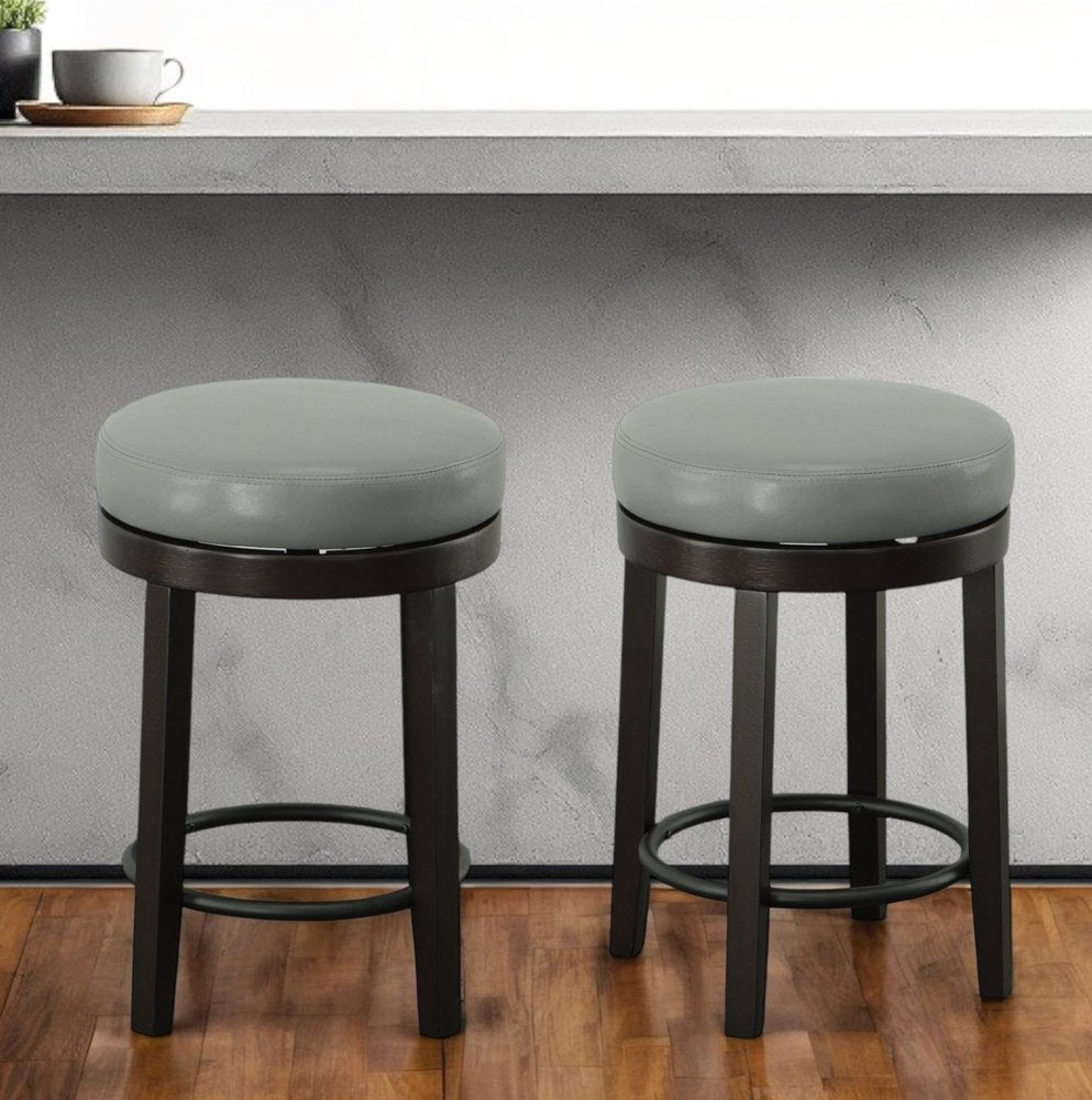 Set of Two 24" Gray and Espresso Faux Leather and Solid Wood Backless Counter Height Swivel Bar Chairs