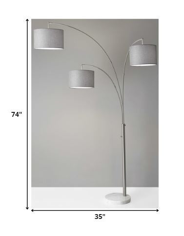 74" Brass Three Light Arc Floor Lamp With Off White Fabric Drum Shade