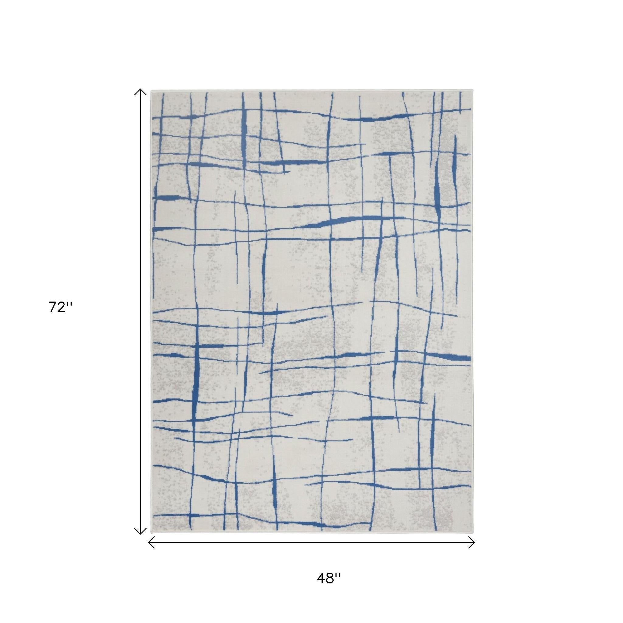 4' X 6' Ivory And Blue Geometric Distressed Area Rug