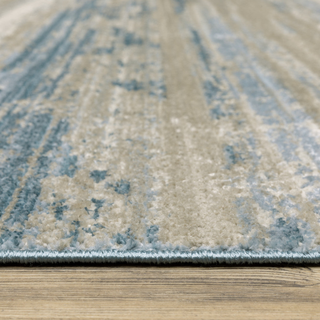 8' X 11' Ivory Beige Grey Blue And Tan Abstract Power Loom Stain Resistant Area Rug With Fringe