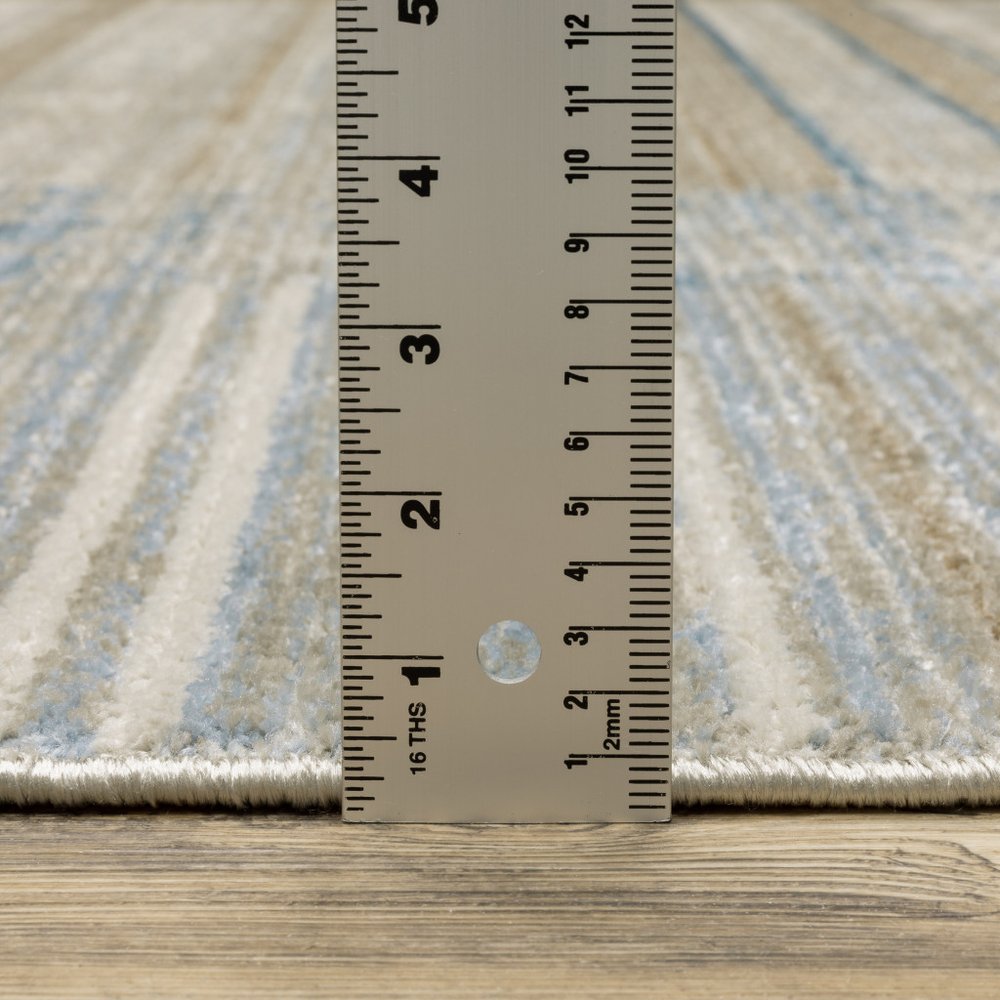 6' X 9' Blue Dark Blue Teal Grey Ivory Beige And Tan Geometric Power Loom Stain Resistant Area Rug With Fringe