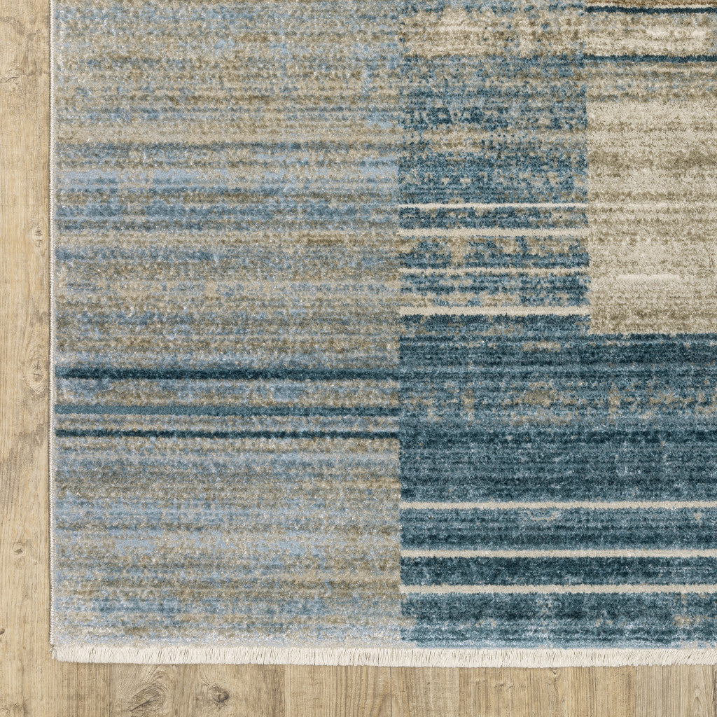 10' X 13' Blue Dark Blue Teal Grey Ivory Beige And Tan Geometric Power Loom Stain Resistant Area Rug With Fringe