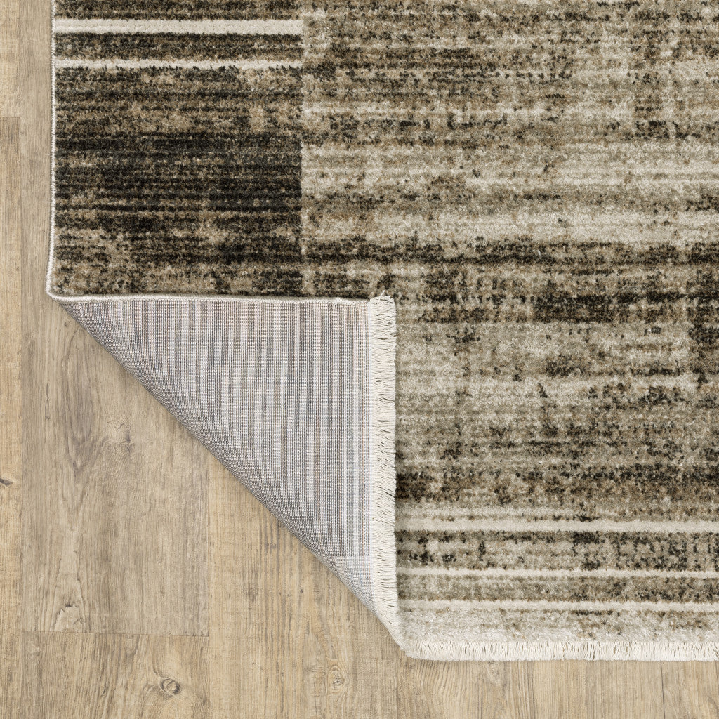 8' X 11' Beige Charcoal Brown Grey Tan Gold And Blue Geometric Power Loom Stain Resistant Area Rug With Fringe