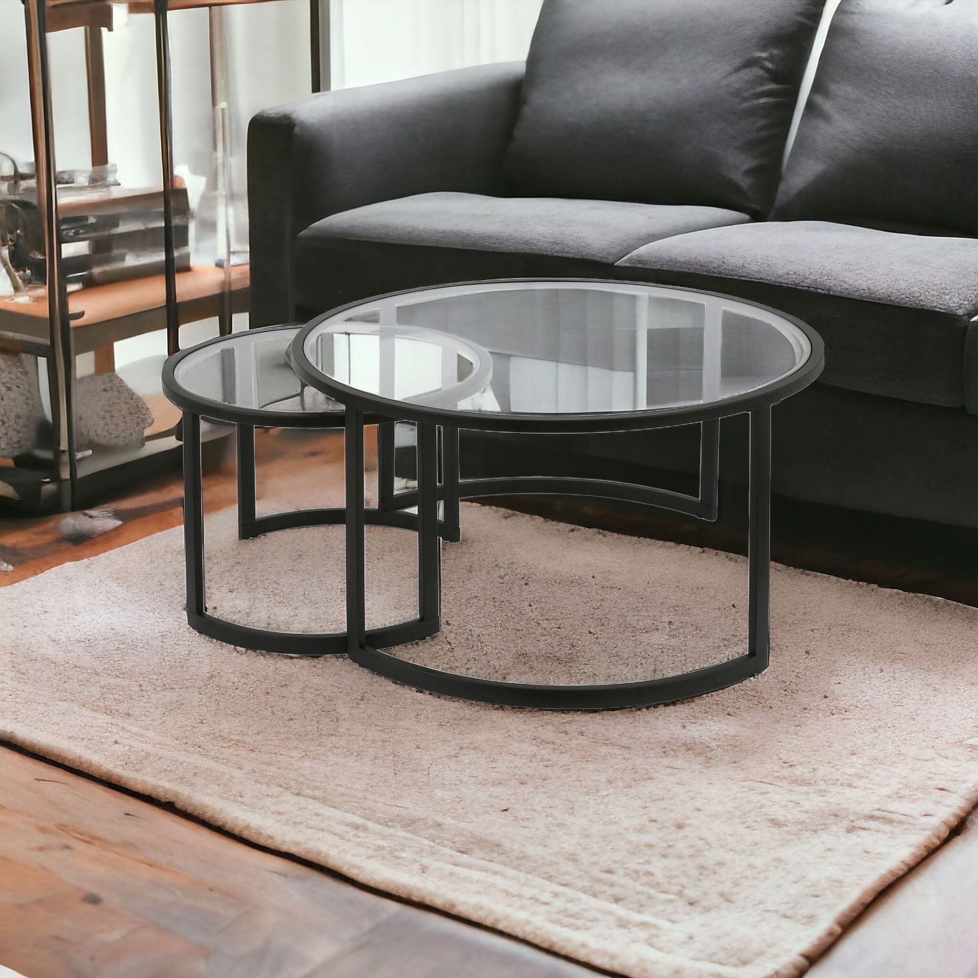 Set of Two Black Glass And Steel Round Sled Nested Coffee Tables